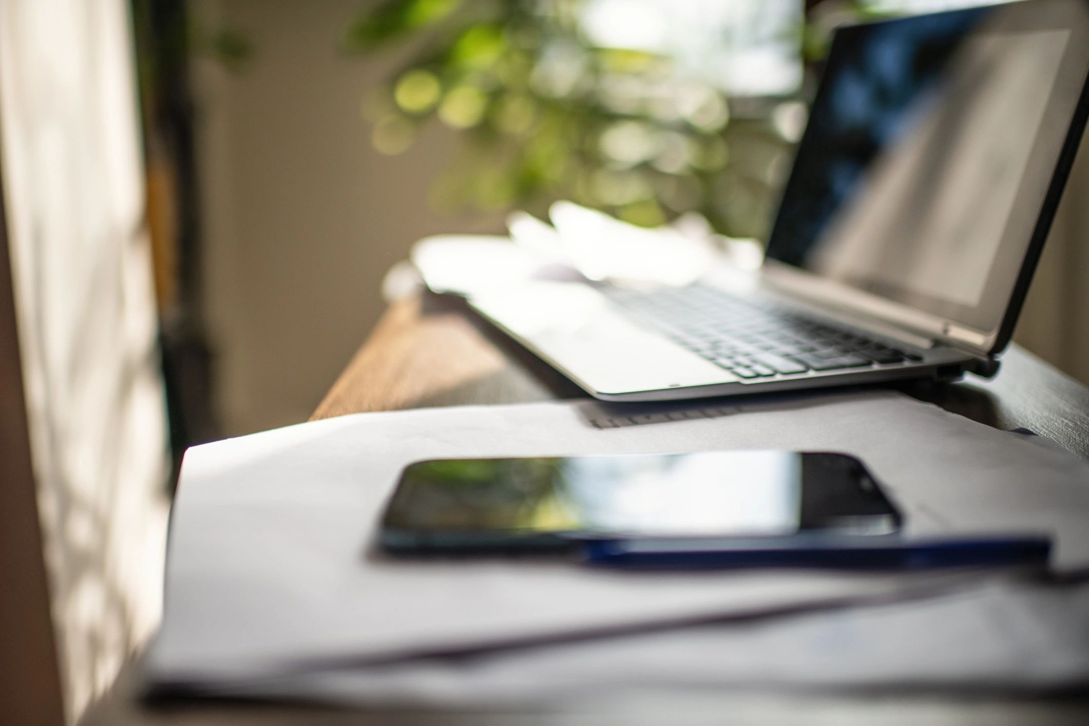 Laptop and printed documents on a desk